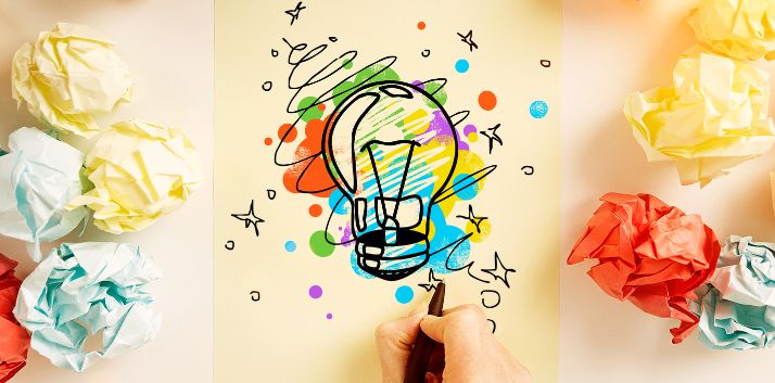 Creative Brief Lightbulb drawn on paper with colorful splashes and wads of paper nearby HOW Design Live